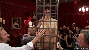 Slaves are caged and toyed at party